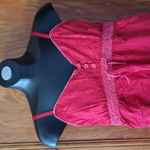 Summer top with embroidered floral detail, three buttons.